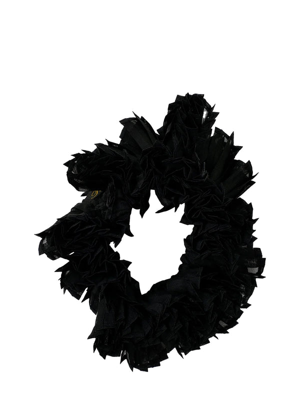 A black ruffled hair scrunchie made of layered, textured fabric, shown against a plain white background.