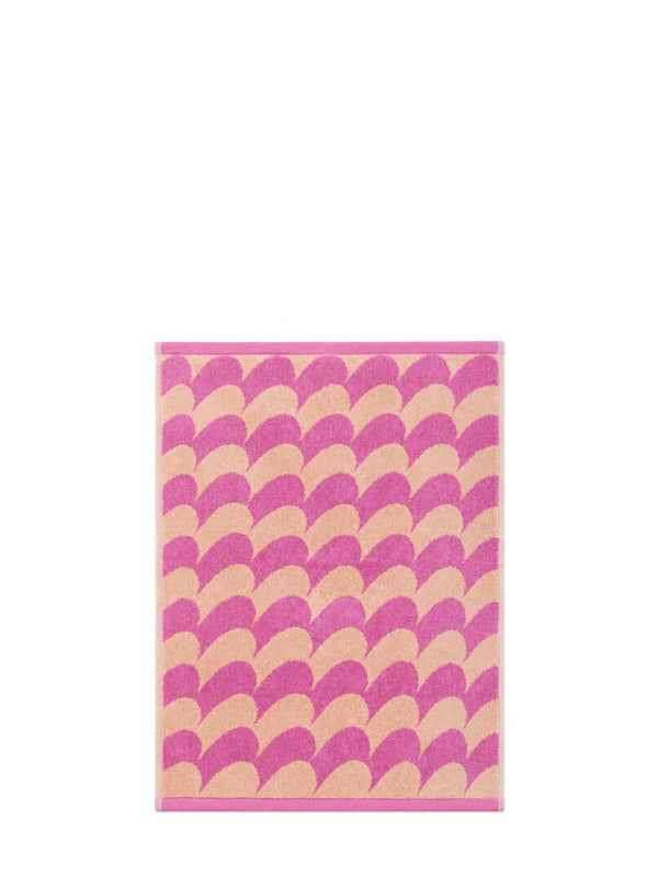 A rectangular terry cotton hand towel with a pink and pastel peach curvy mountain line or fish-scale pattern and a solid pink border, shown against a plain white background.