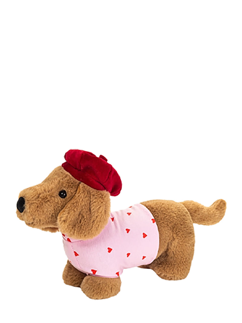 A plush dachshund toy wearing a red beret and a pink shirt with small red hearts, isolated on a white background.
