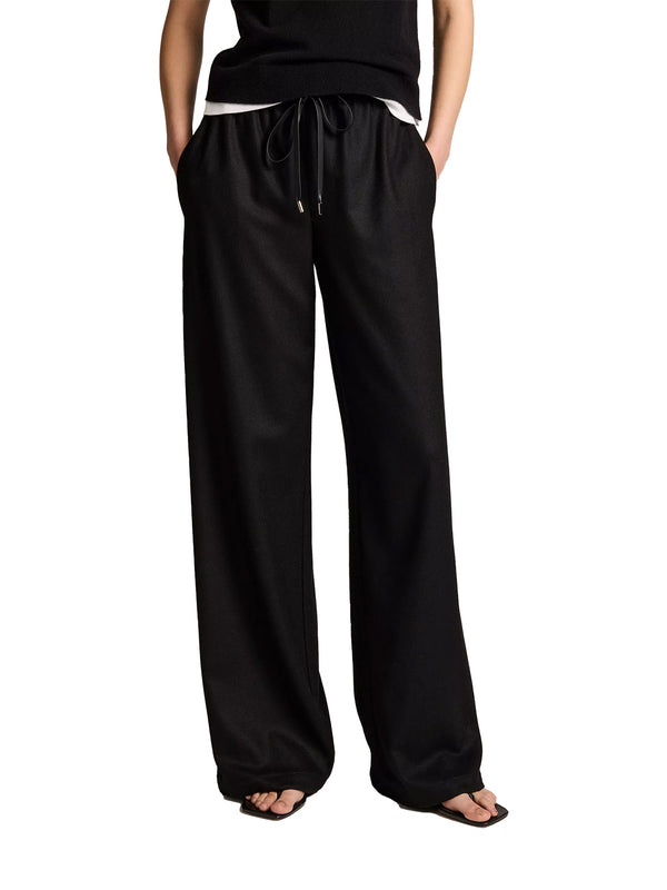 Black wide-leg drawstring pants with side pockets, shown on a model from the waist down against a white background.