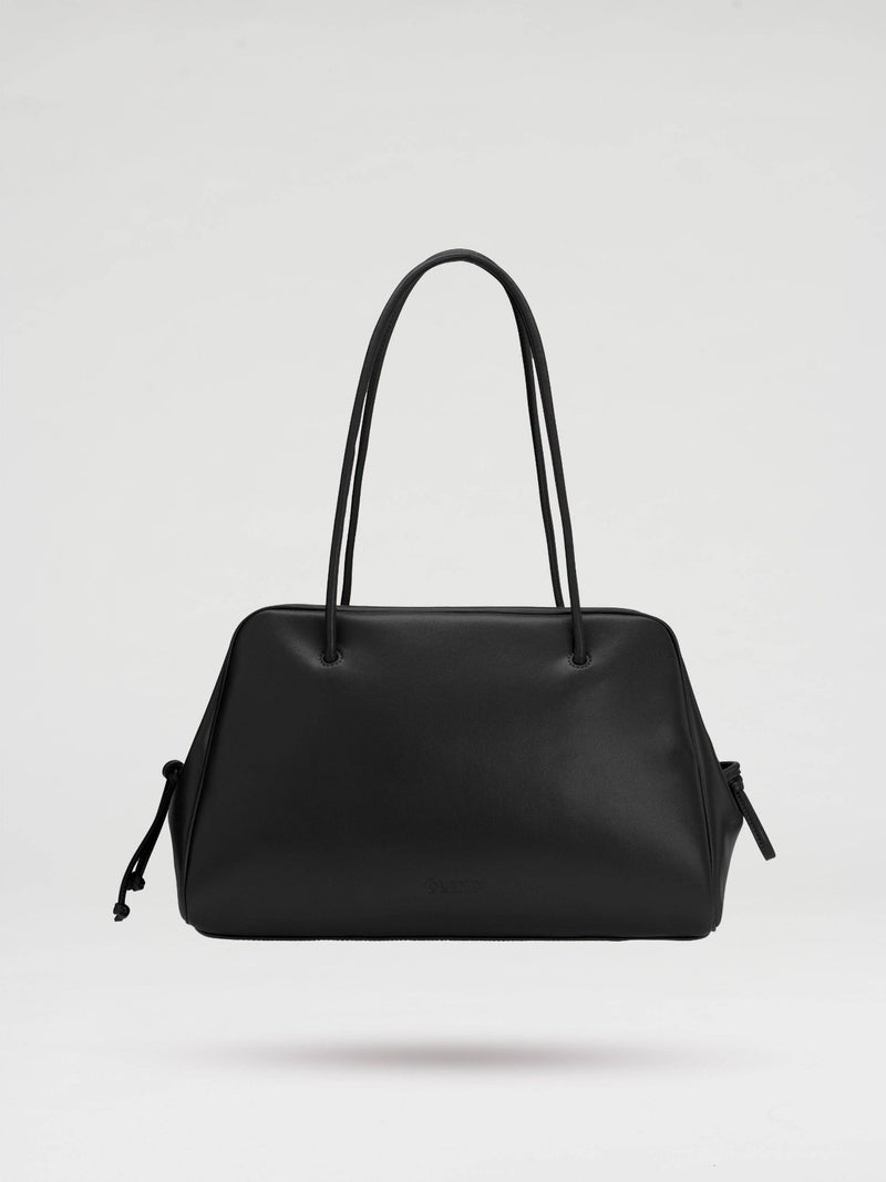 Black handbag on a light gray background