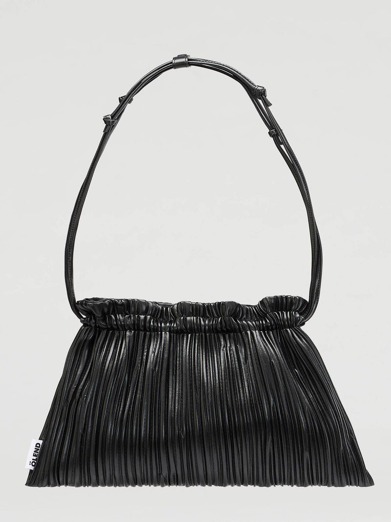 A black pleated leather shoulder bag with a single strap and a gathered top opening, shown against a light gray background.