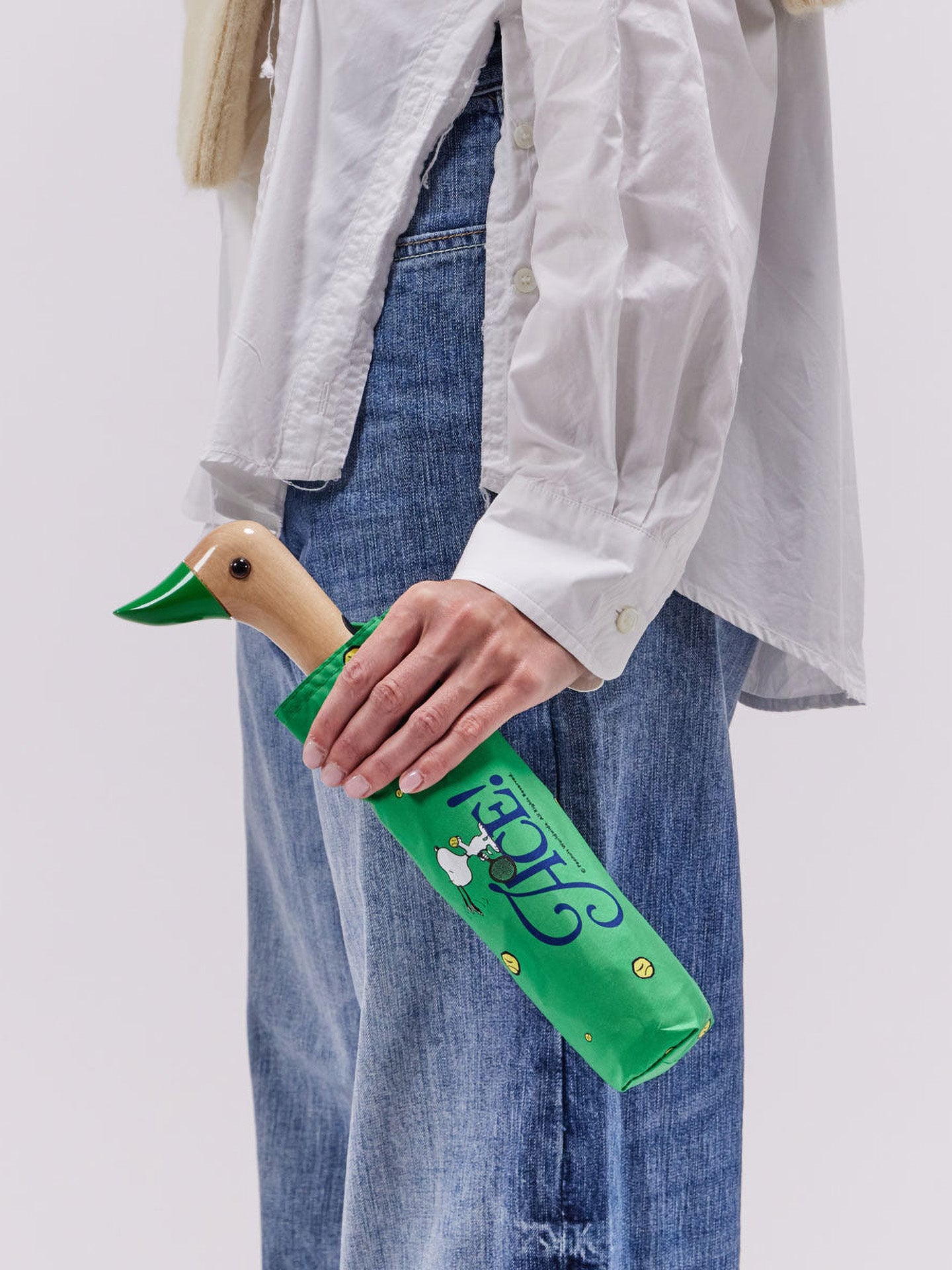 Person holding a green umbrella 