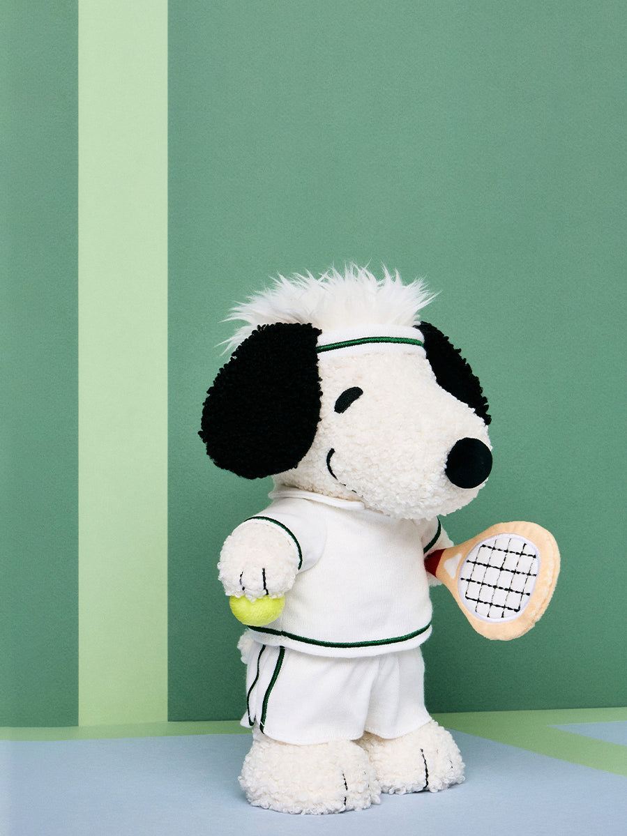 Snoopy Plush toy in tennis attire against a green background