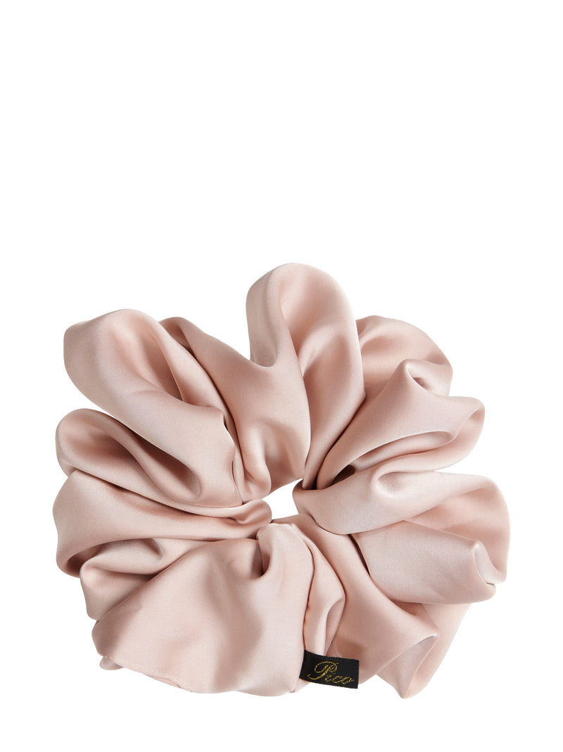 A dusty pink satin scrunchie with a small black and gold 'Pico' brand tag, shown on a solid white background.