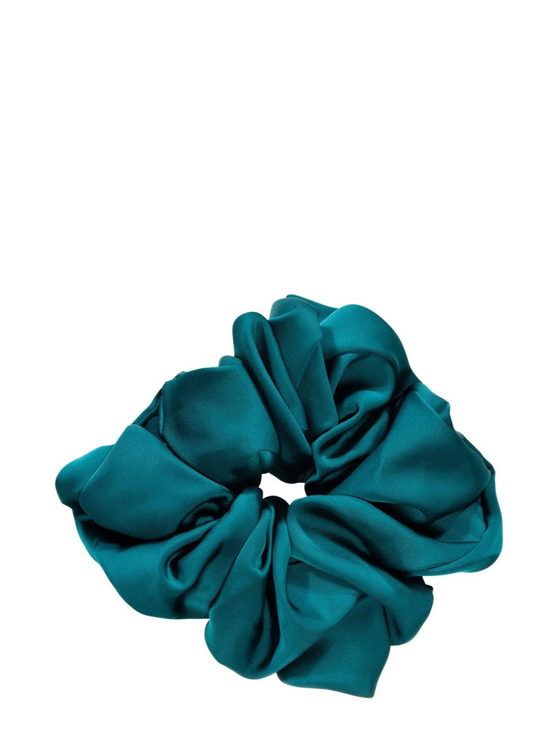 A single satin hair scrunchie in a rich teal color, photographed against a solid white background.
