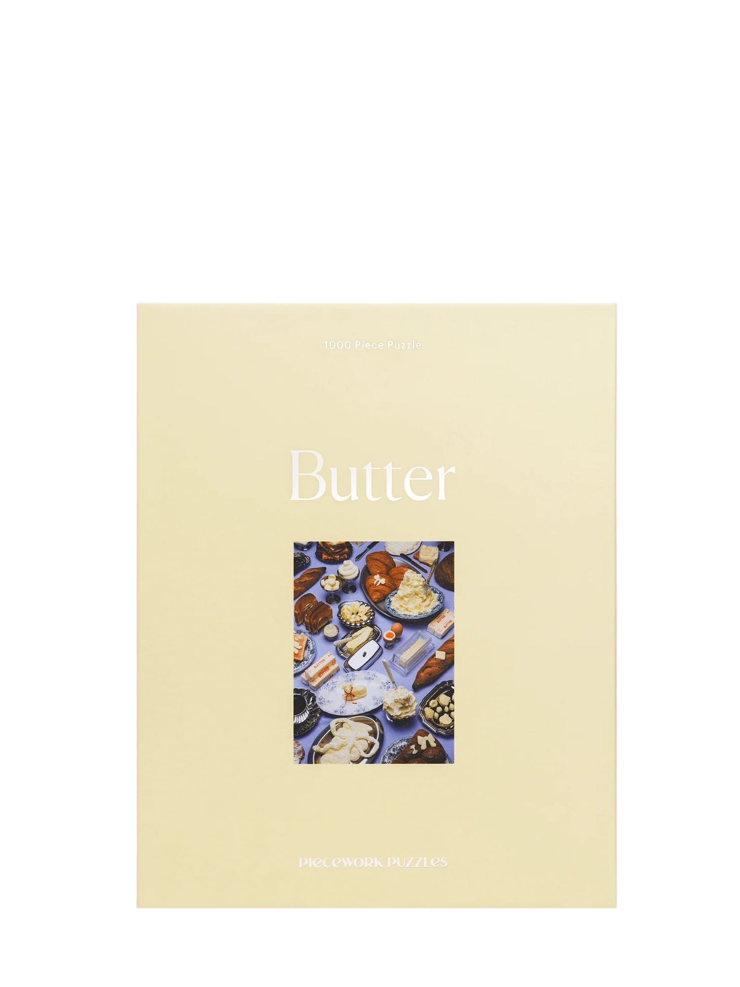 Puzzle box 'Butter' with a cover featuring images of butter and related products on a light purple background.