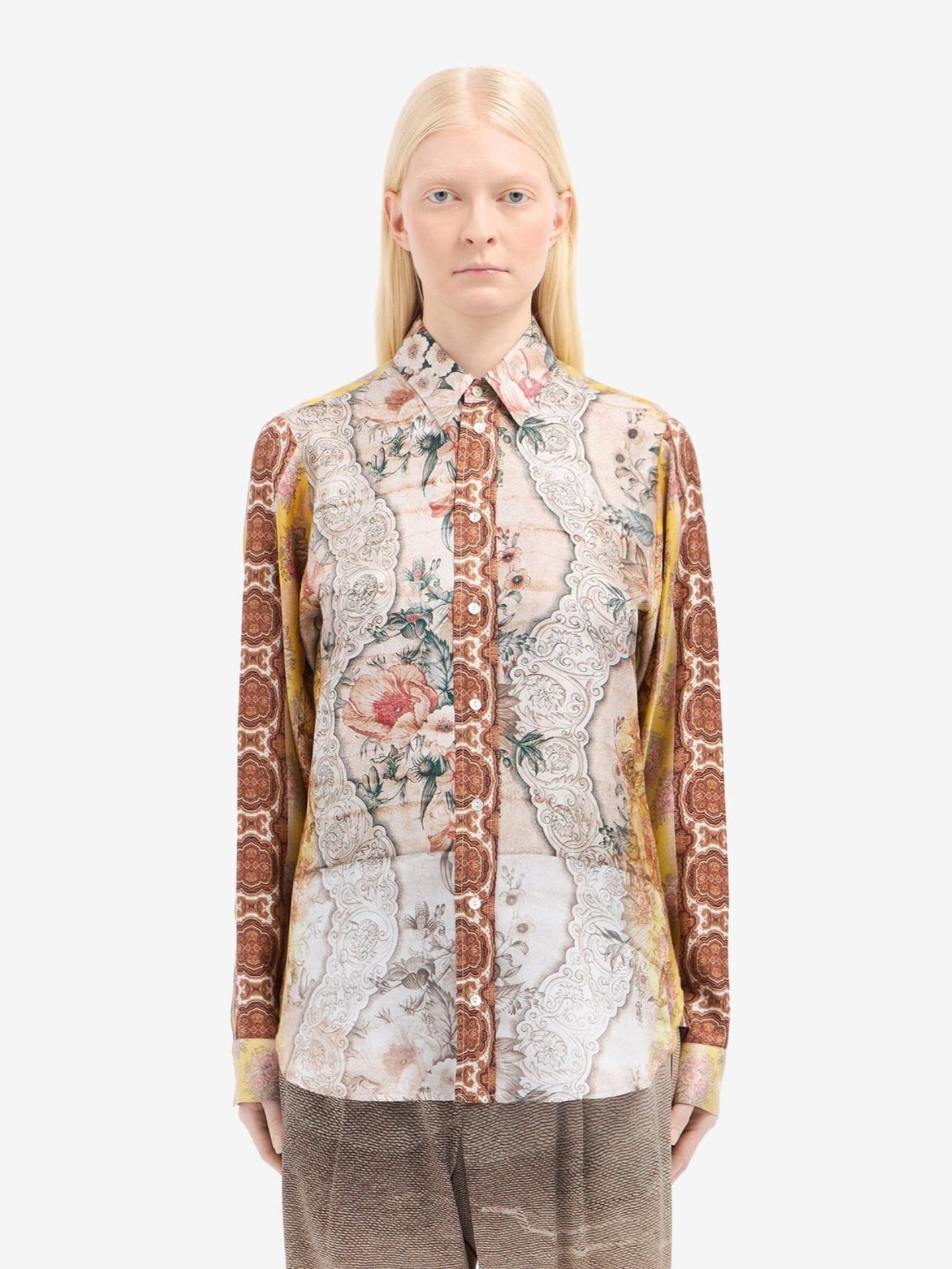 Person wearing a patterned shirt with a white background