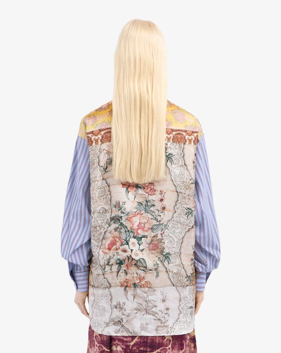Person wearing a patterned shirt with a white background