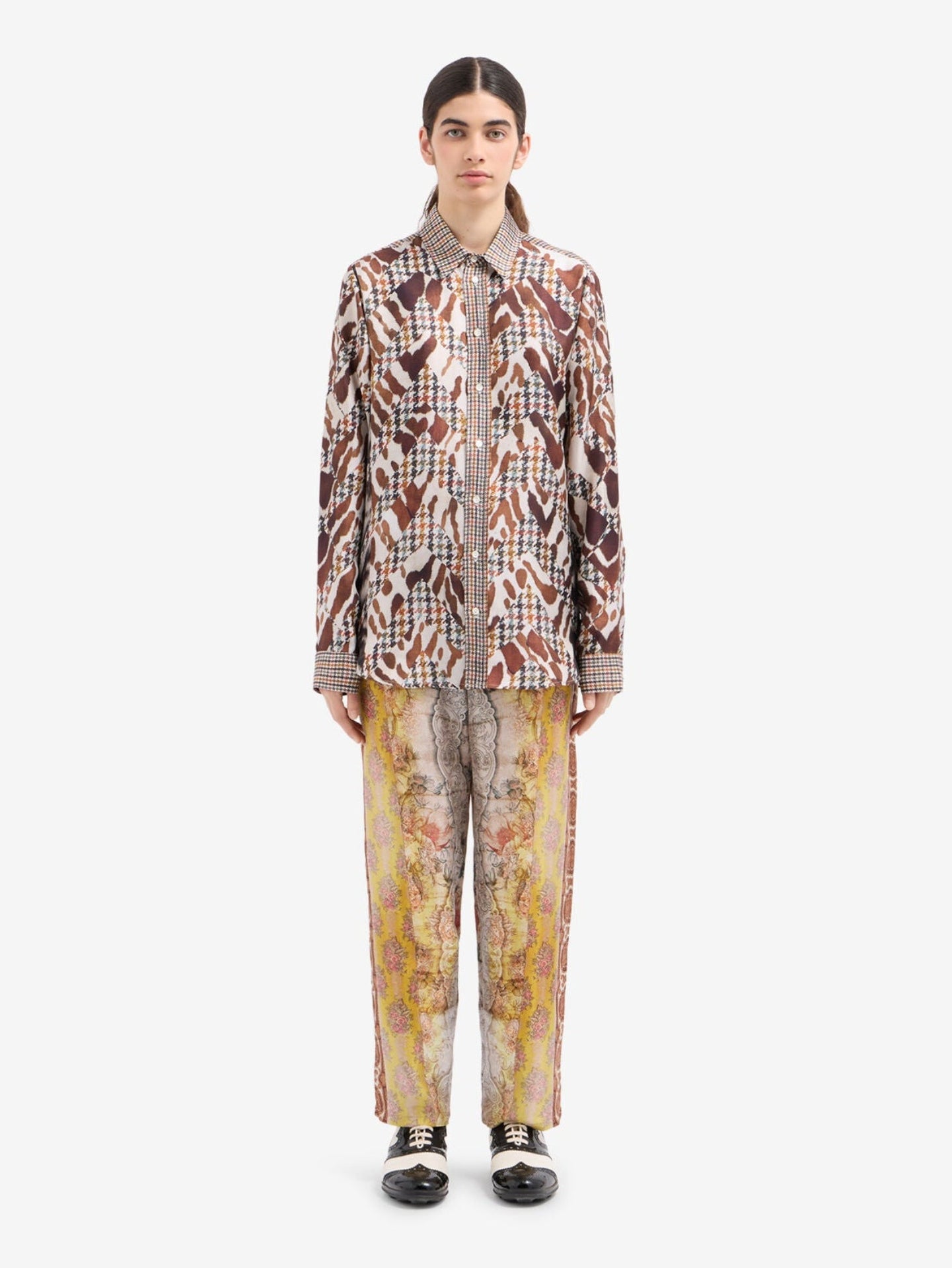 Person wearing a patterned outfit with a white background