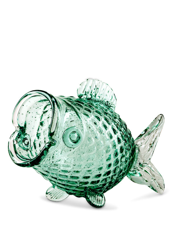 Green glass fish ornament on a white background