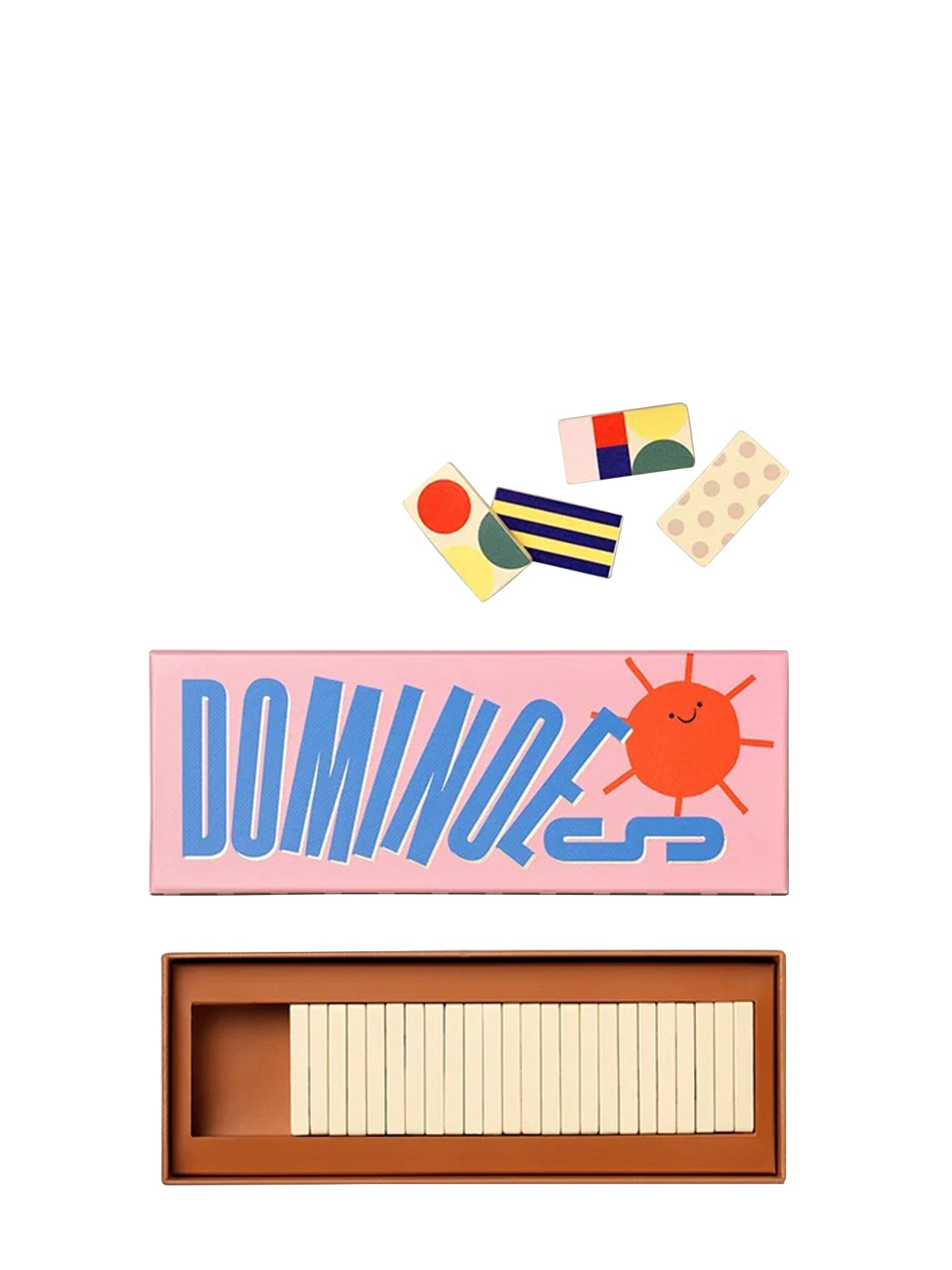 A set of colorful dominoes shown on a white background, including the pink box with blue 'DOMINOES' lettering and a smiling sun illustration, several loose domino pieces above, and an open brown tray holding cream-colored domino tiles below.