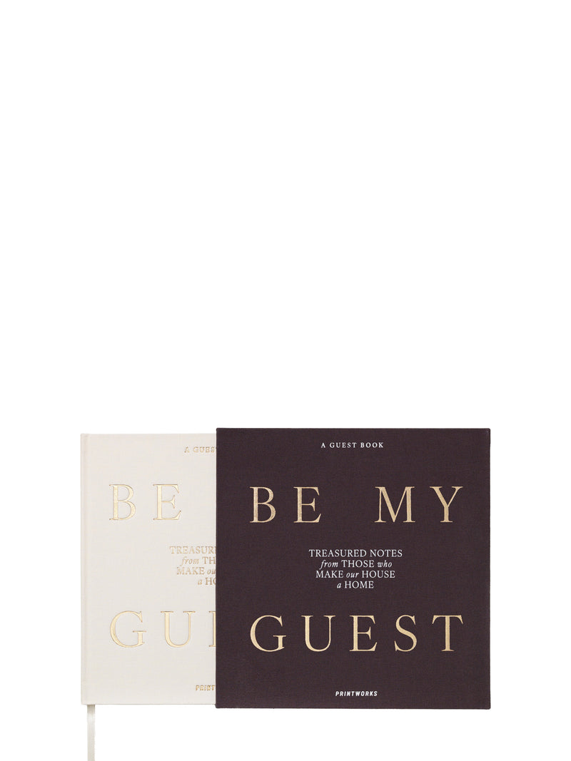 Off-white guestbook titled 'Be My Guest' pulled out from its darker cover on a white background