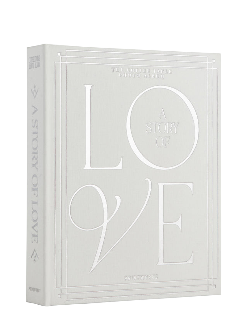 A white off-white photo album with silver foiled text titled 'A Story of Love' on the cover, designed for holding wedding photos.
