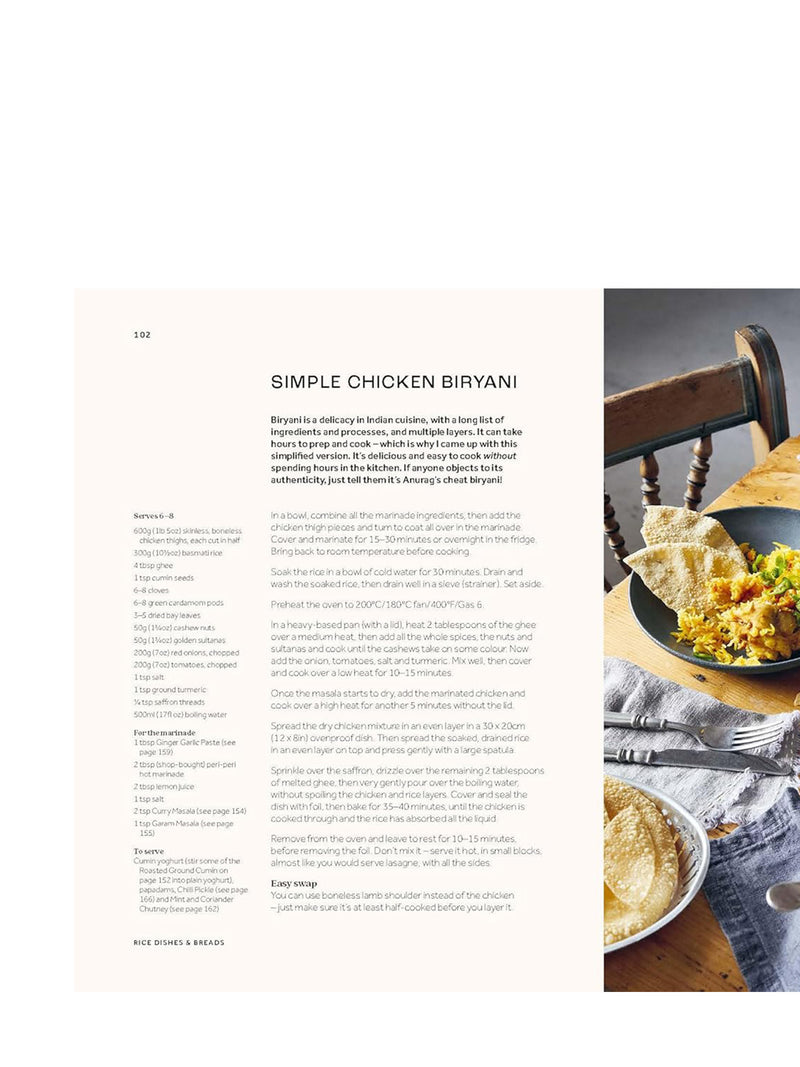 Page from a cookbook featuring a recipe for Simple Chicken Biryani with a photograph of the dish on a wooden table.