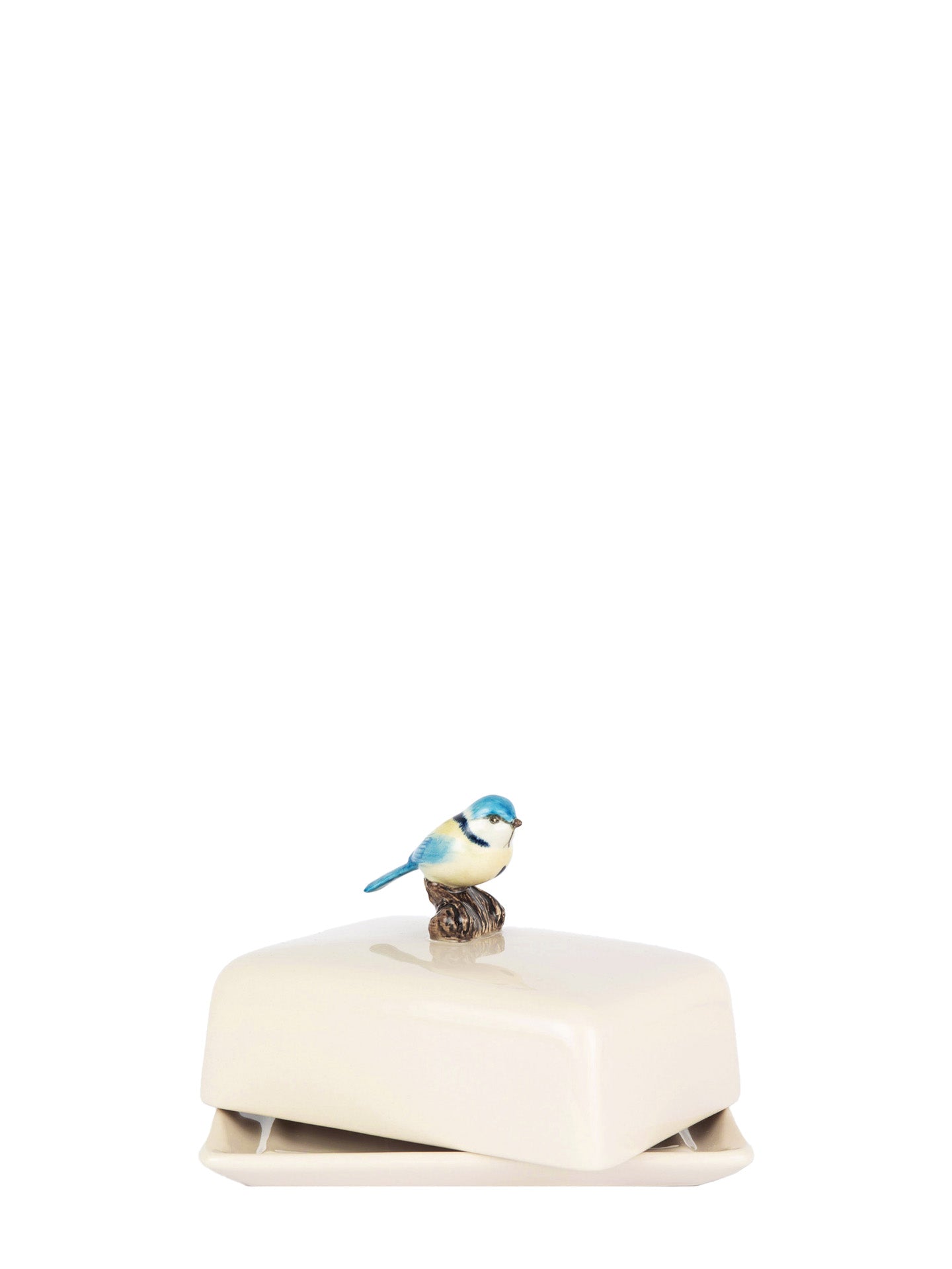 Butter dish with a bird on top of a white box on a white background