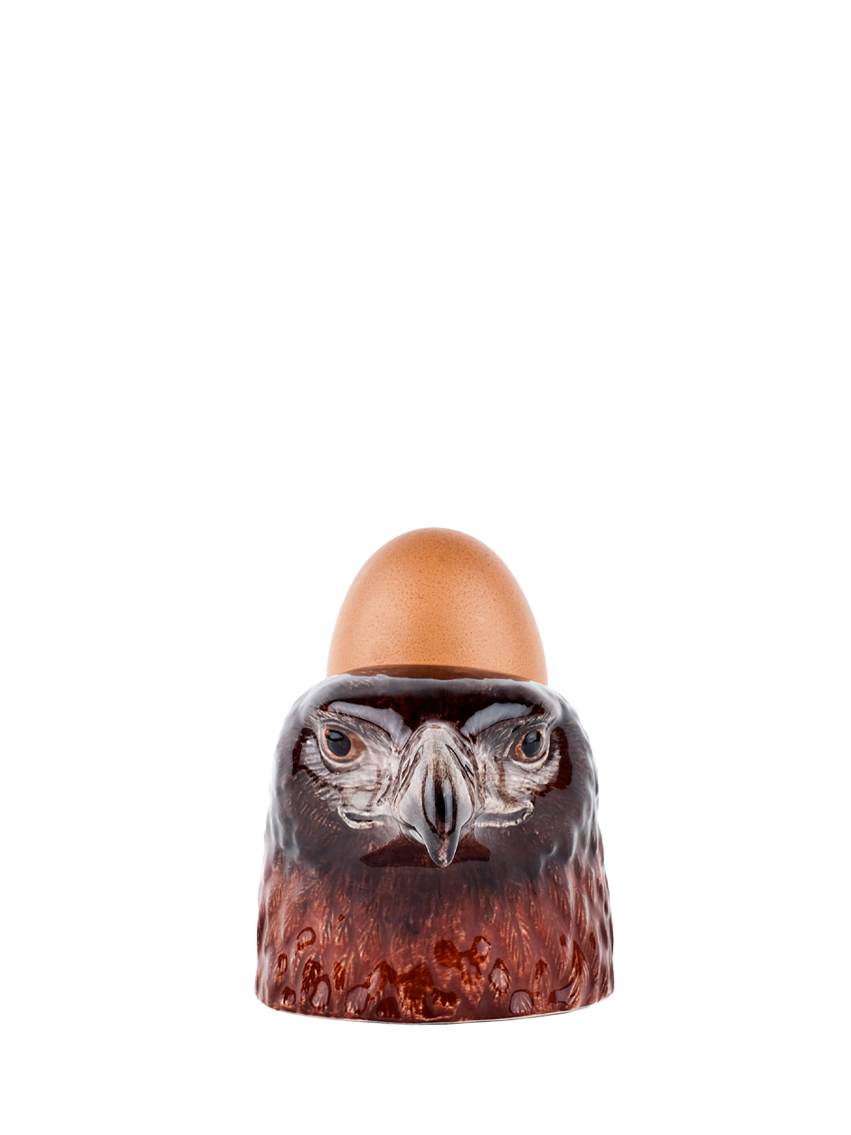 Eagle-shaped egg holder with an egg on a white background