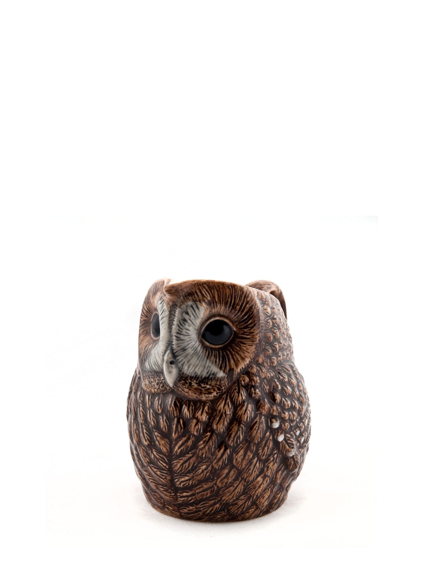 A small owl jug with detailed brown and black feather patterns, large dark eyes, and a pale gray beak, photographed against a plain white background.