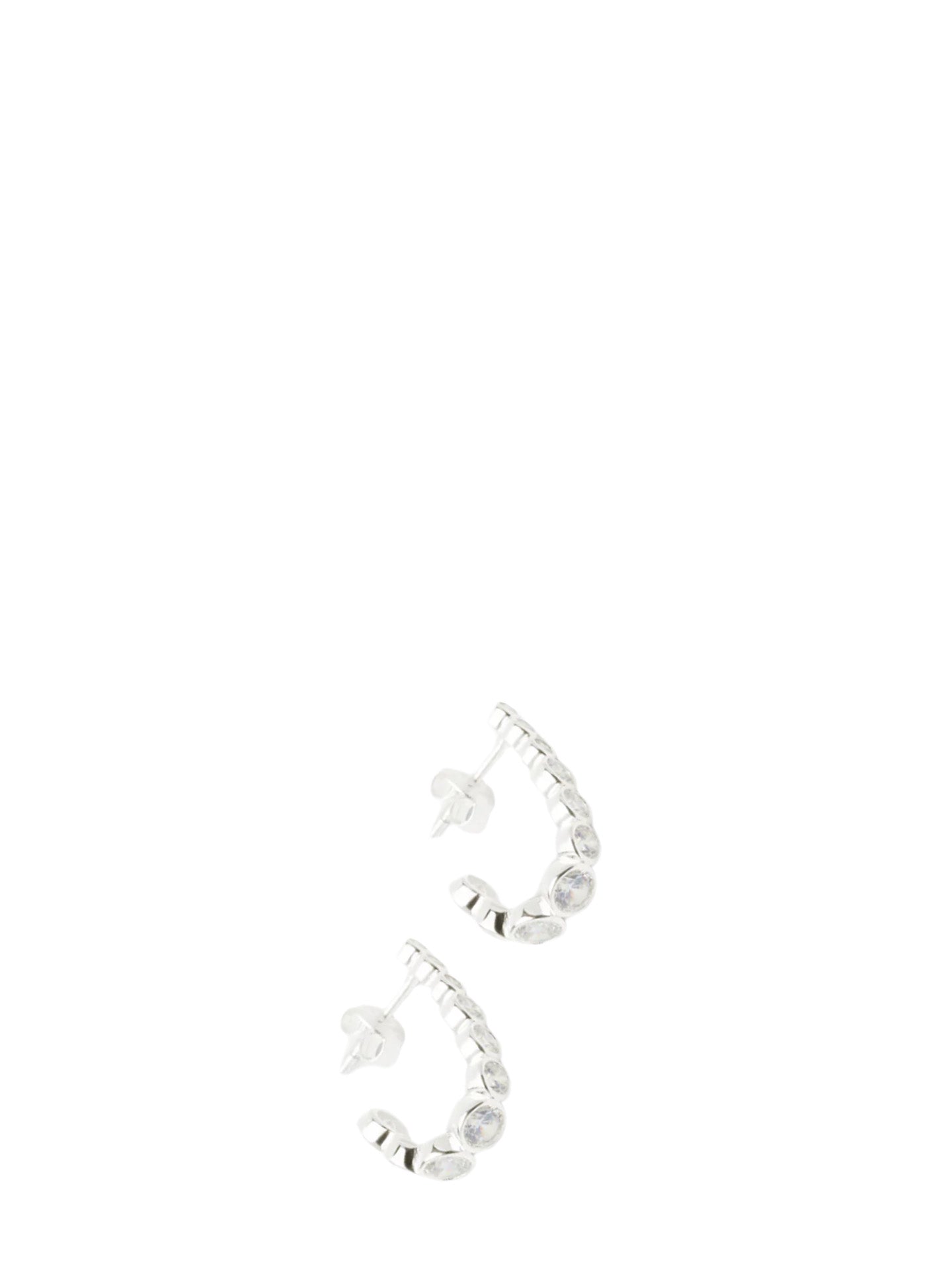 Silver half-moon hoop earrings with a row of clear cubic zirconite stones have a stud fastening on a white background