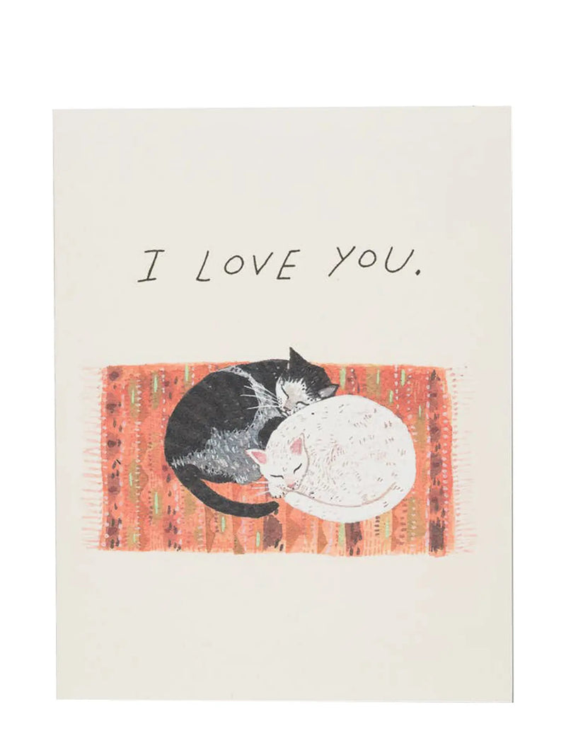 A square art print or card with the text 'I LOVE YOU.' above an illustration of a black cat curled up on a textured orange and red blanket next to a white cat, shown against a plain white background.