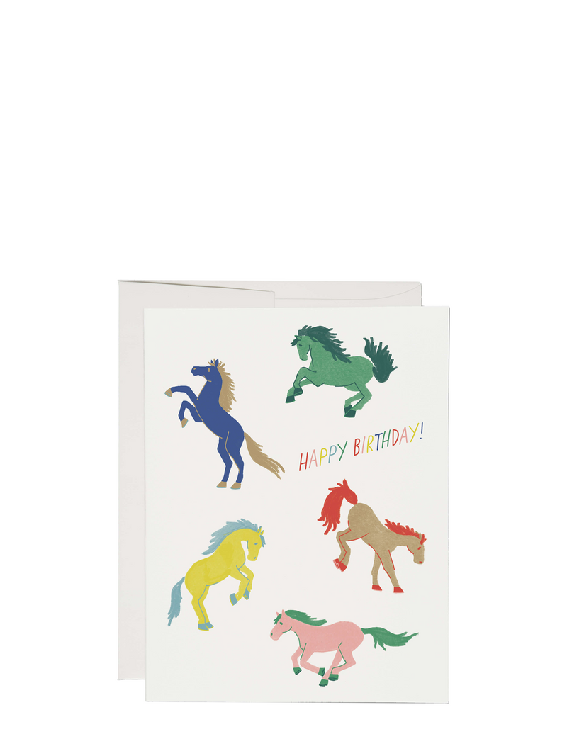 A birthday card with colorful horse illustrations and the text 'Happy Birthday' on it. The card is placed against a white background.