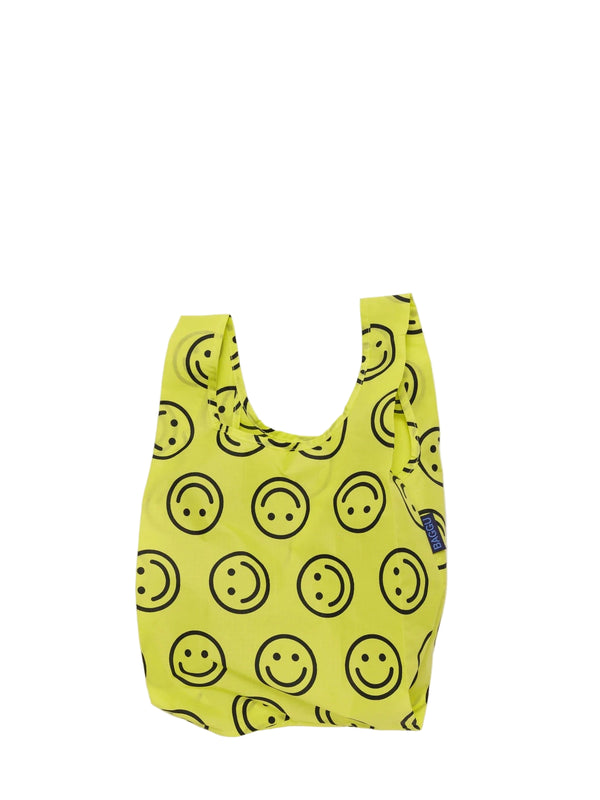 Yellow reusable bag with smiley face pattern on a white background