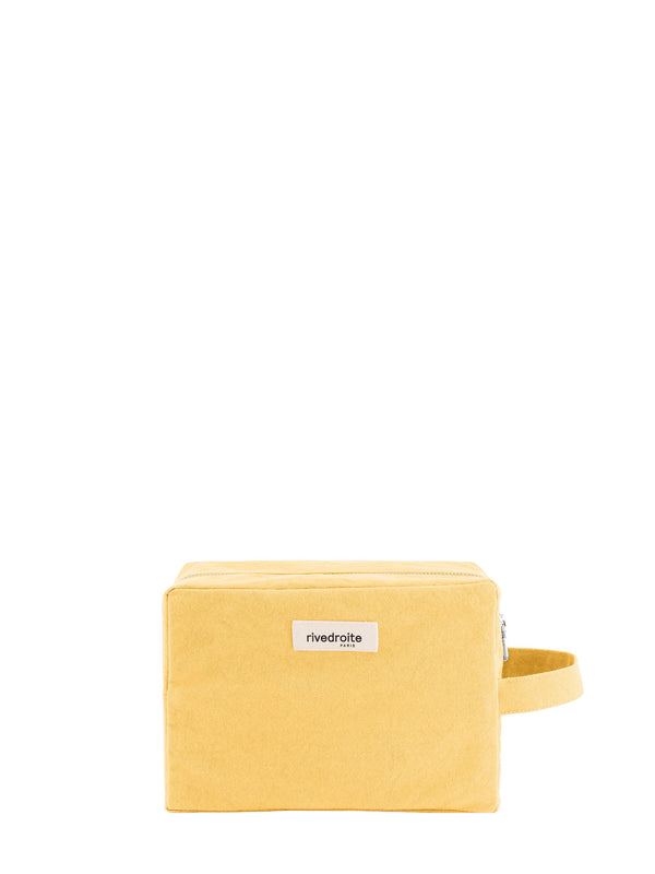 A yellow rectangular cotton canvas toiletry case with a zipper, a matching wrist strap and a small white label reading 'rivedroite paris' on a plain white background.