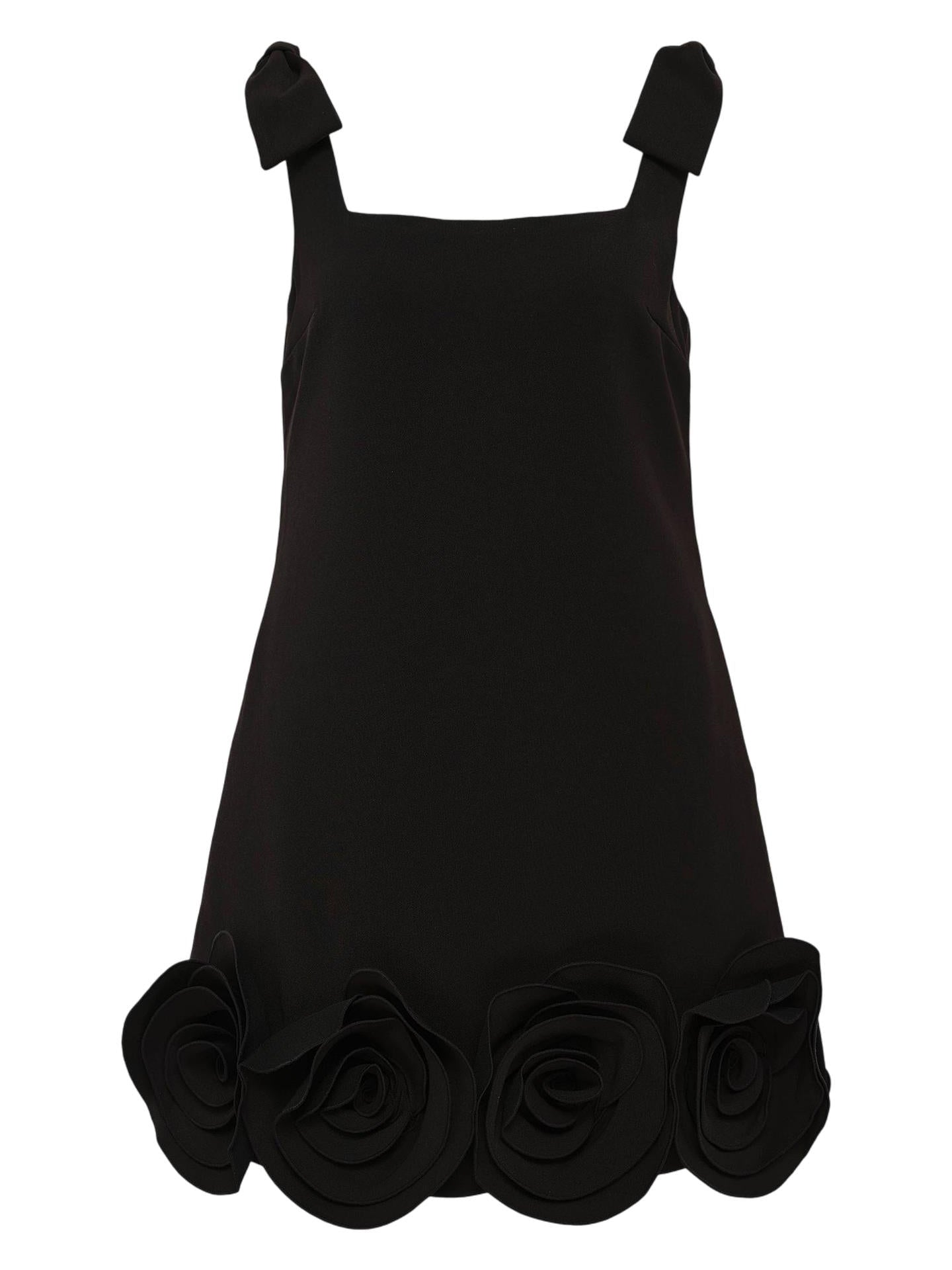 Black mini dress with 3D flower and shoulder bows against white background