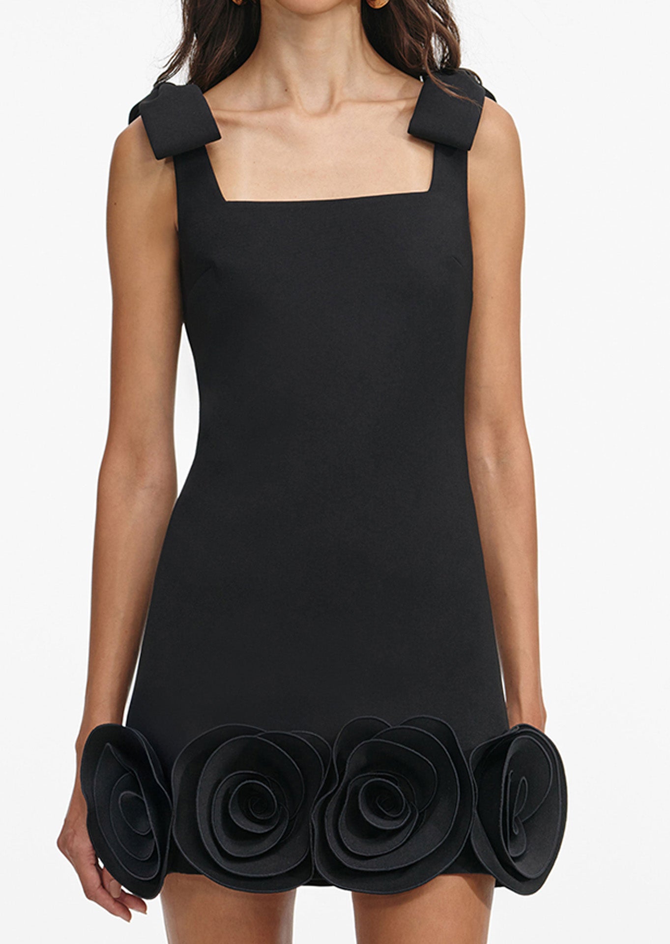 Black dress with 3d floral details on a white background
