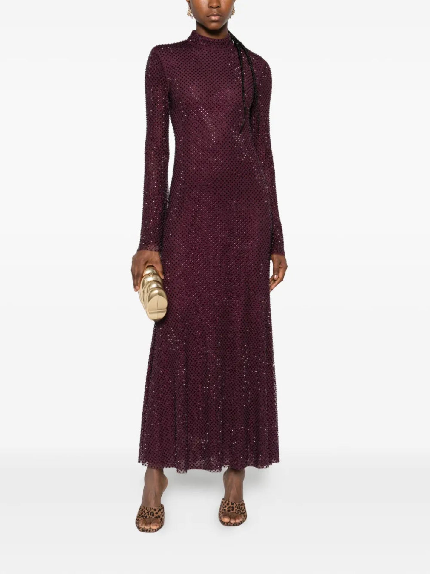 Woman wearing a long burgundy dress with a white background