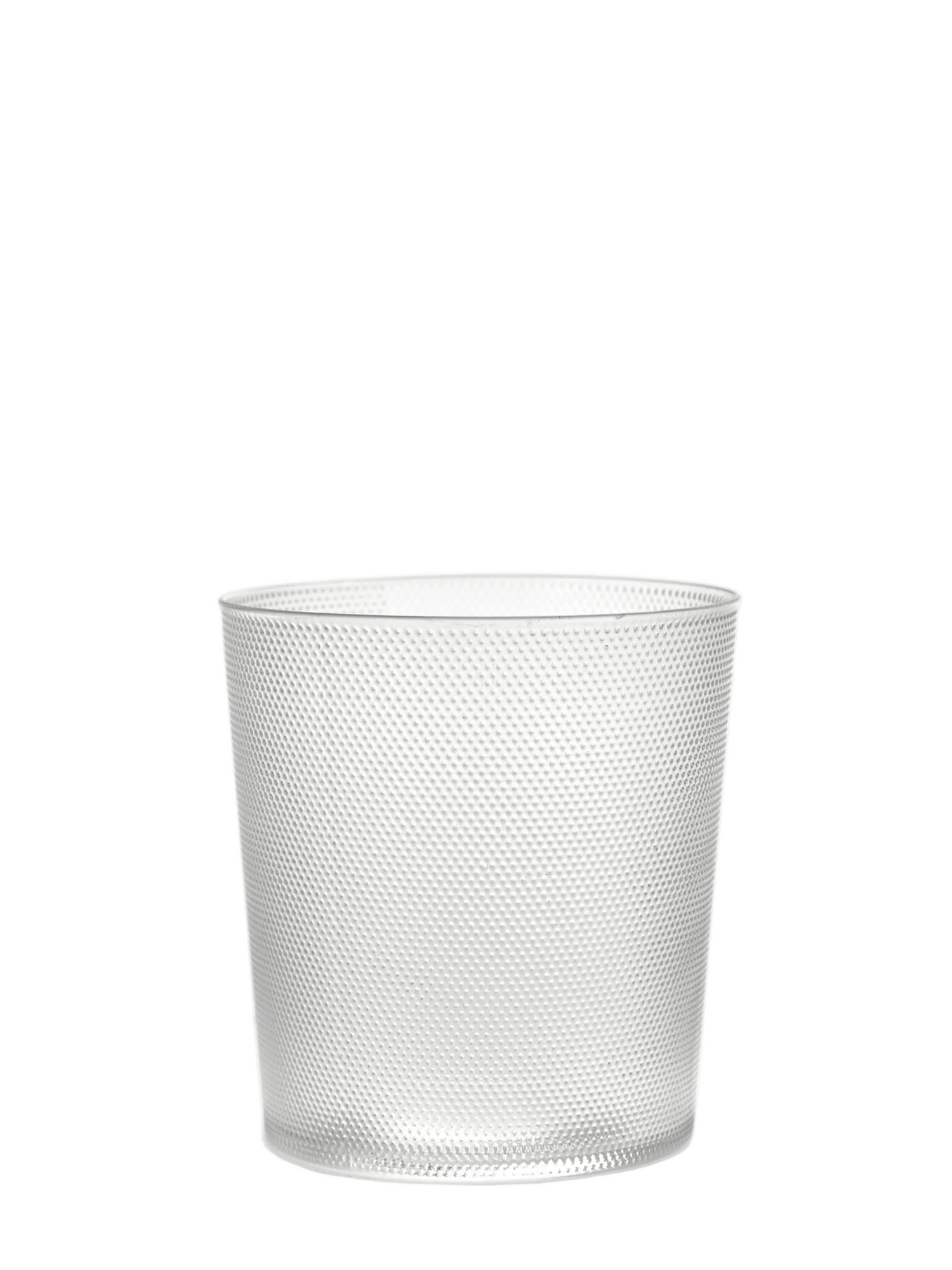 A clear glass tumbler with a textured pattern, part of the La Nouvelle Table collection by Merci.