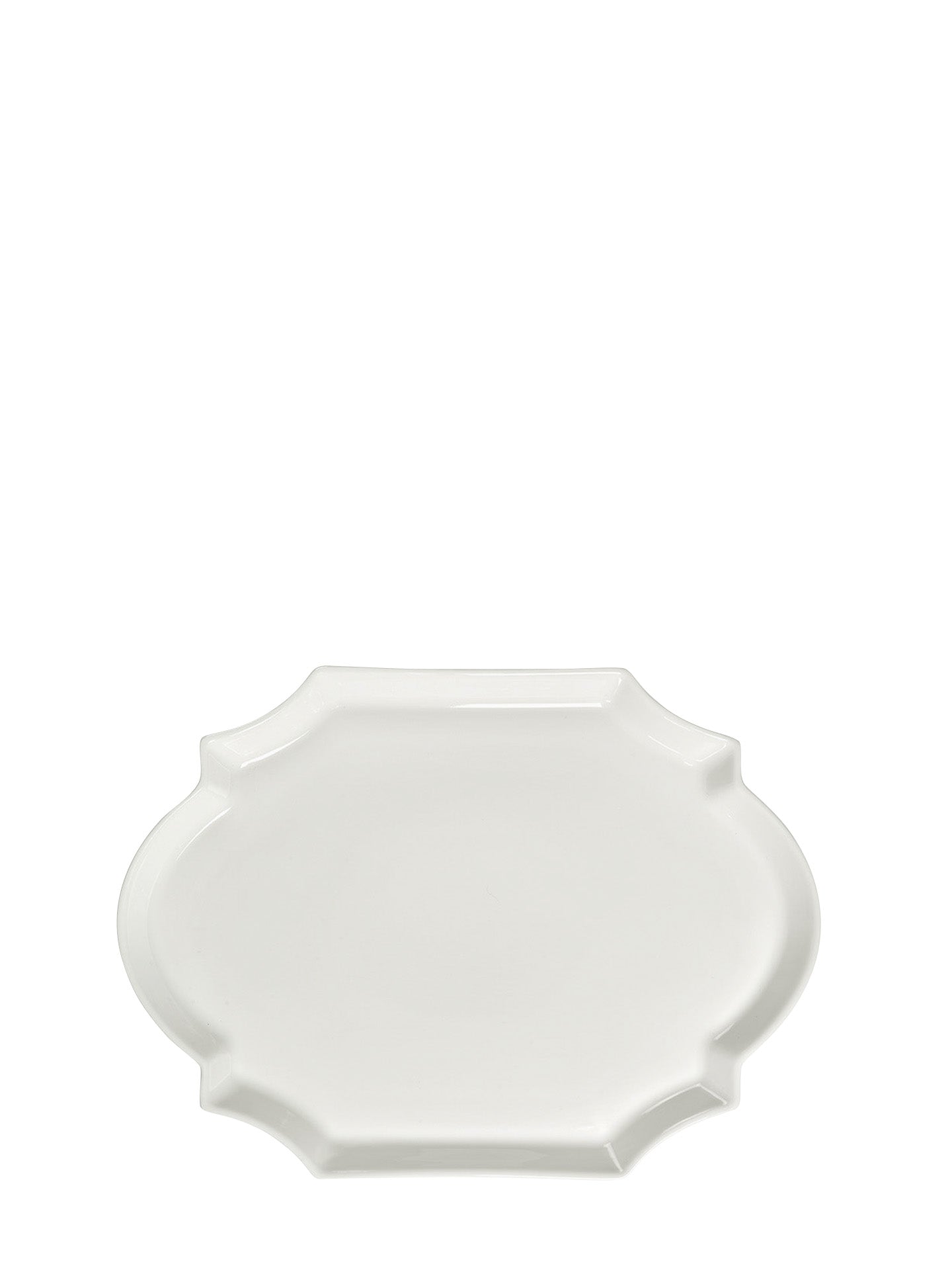 Large white porcelain plate with curvy ovals in otherwise rectangle shape on a white background
