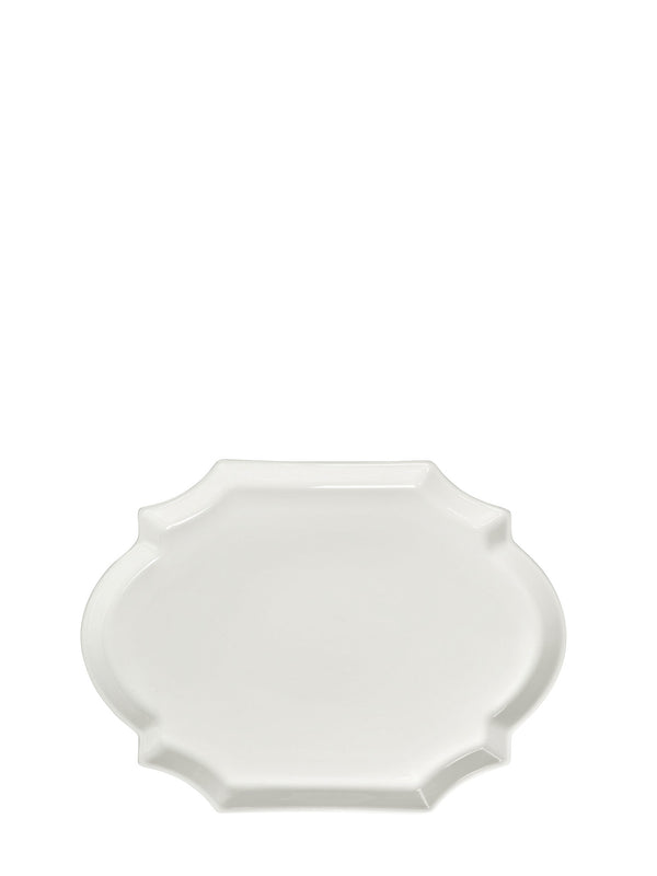 Large white porcelain plate with curvy ovals in otherwise rectangle shape on a white background