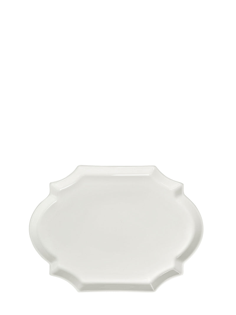 Large white porcelain plate with curvy ovals in otherwise rectangle shape on a white background