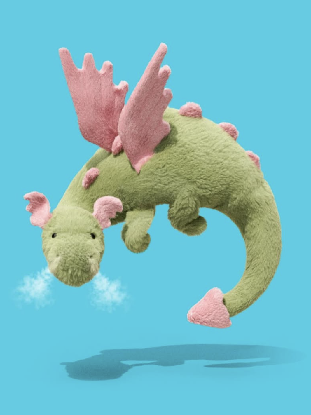 Plush dragon toy with pink accents on a blue background