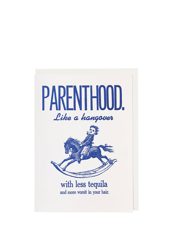 Card with humorous text about parenthood and a cartoon baby on a rocking horse.