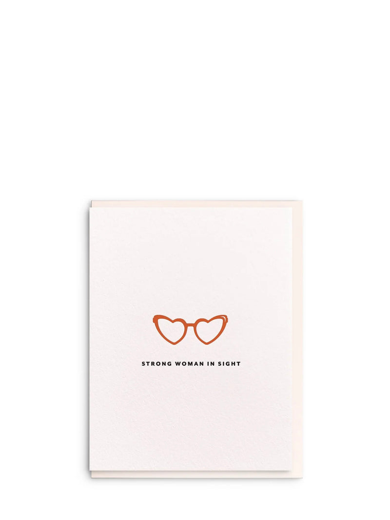 Card with heart-shaped glasses design and text 'Strong woman in sight' on a white background