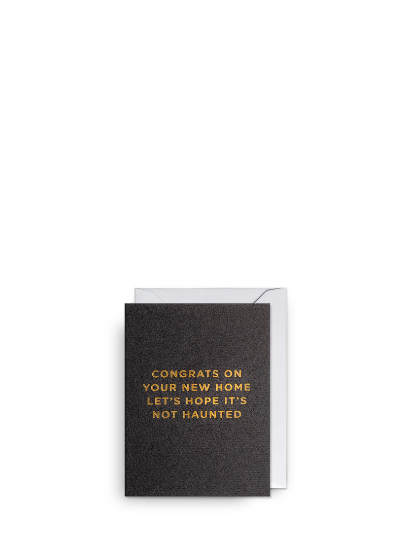 Greeting card with gold text on a black background, featuring a white envelope.