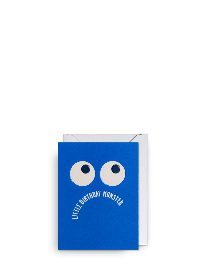 Blue greeting card with white eyes and text 'Little Birthday Monster' on a white background