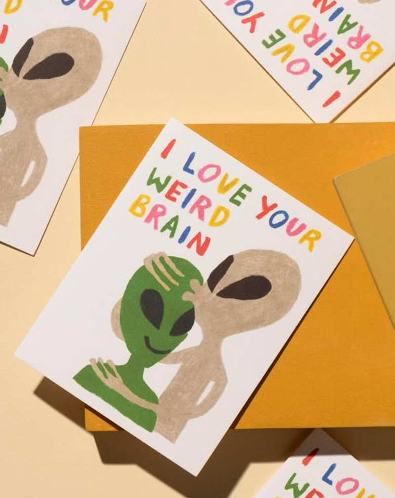 Card with alien illustration and text 'I Love Your Weird Brain' on a yellow background