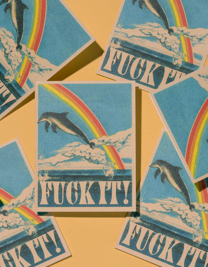 Stickers with dolphins, rainbows, and 'FUCK IT!' text on a yellow background