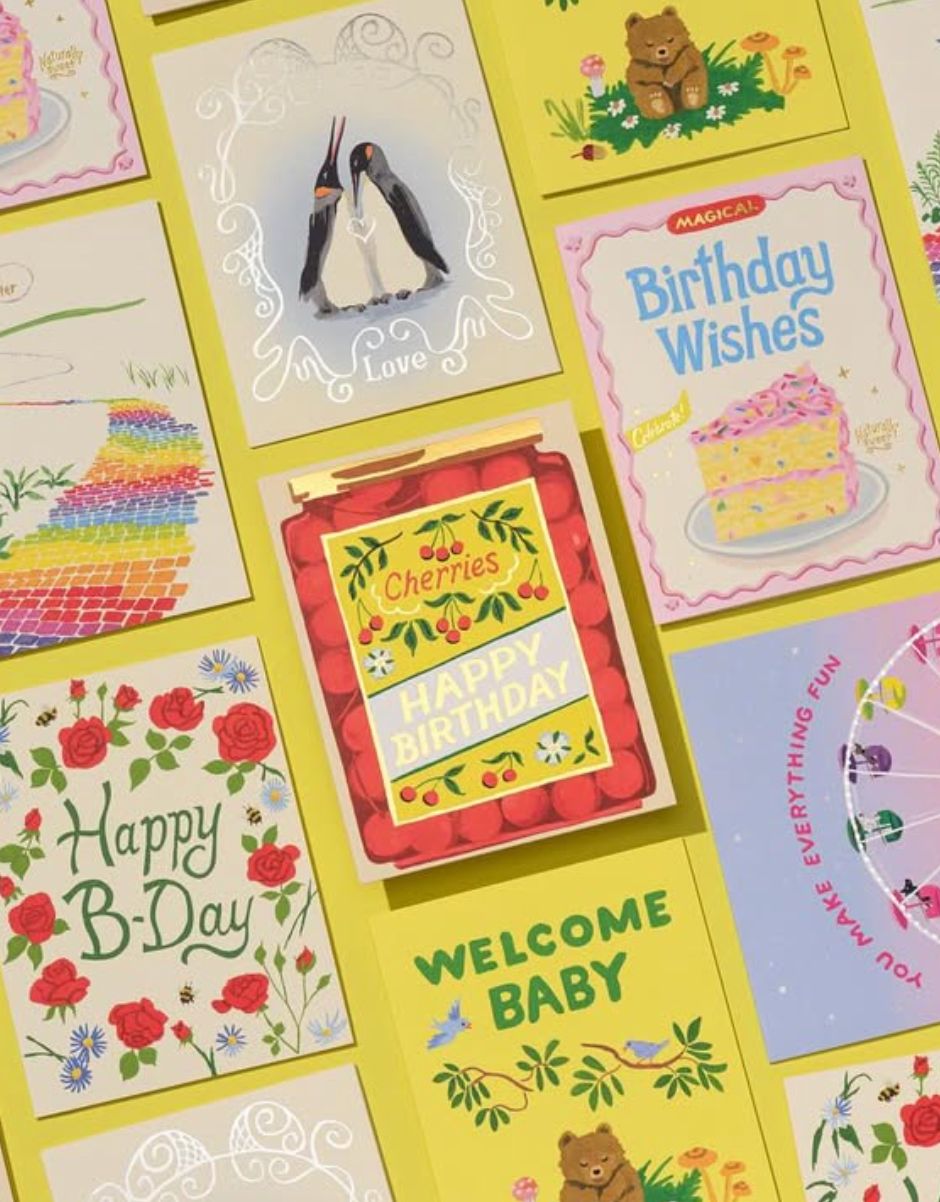 Collection of colorful greeting cards with various designs on a yellow background