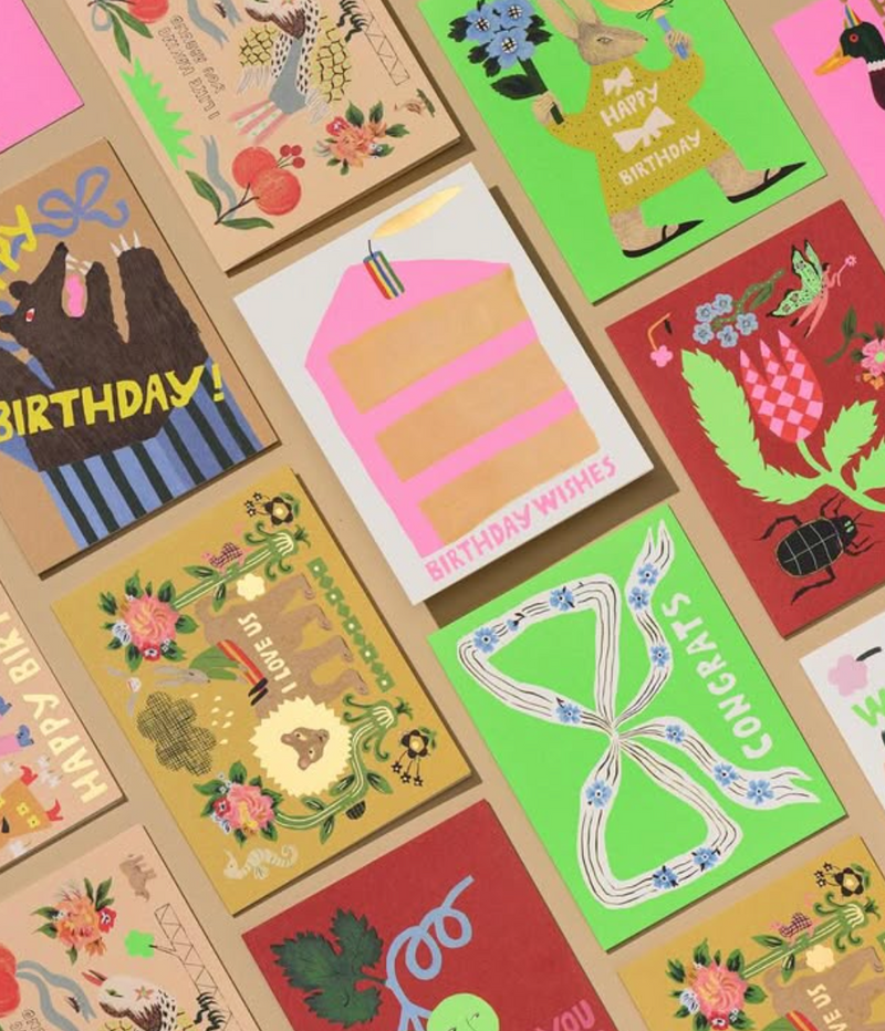 Collection of colorful greeting cards with various designs and text.