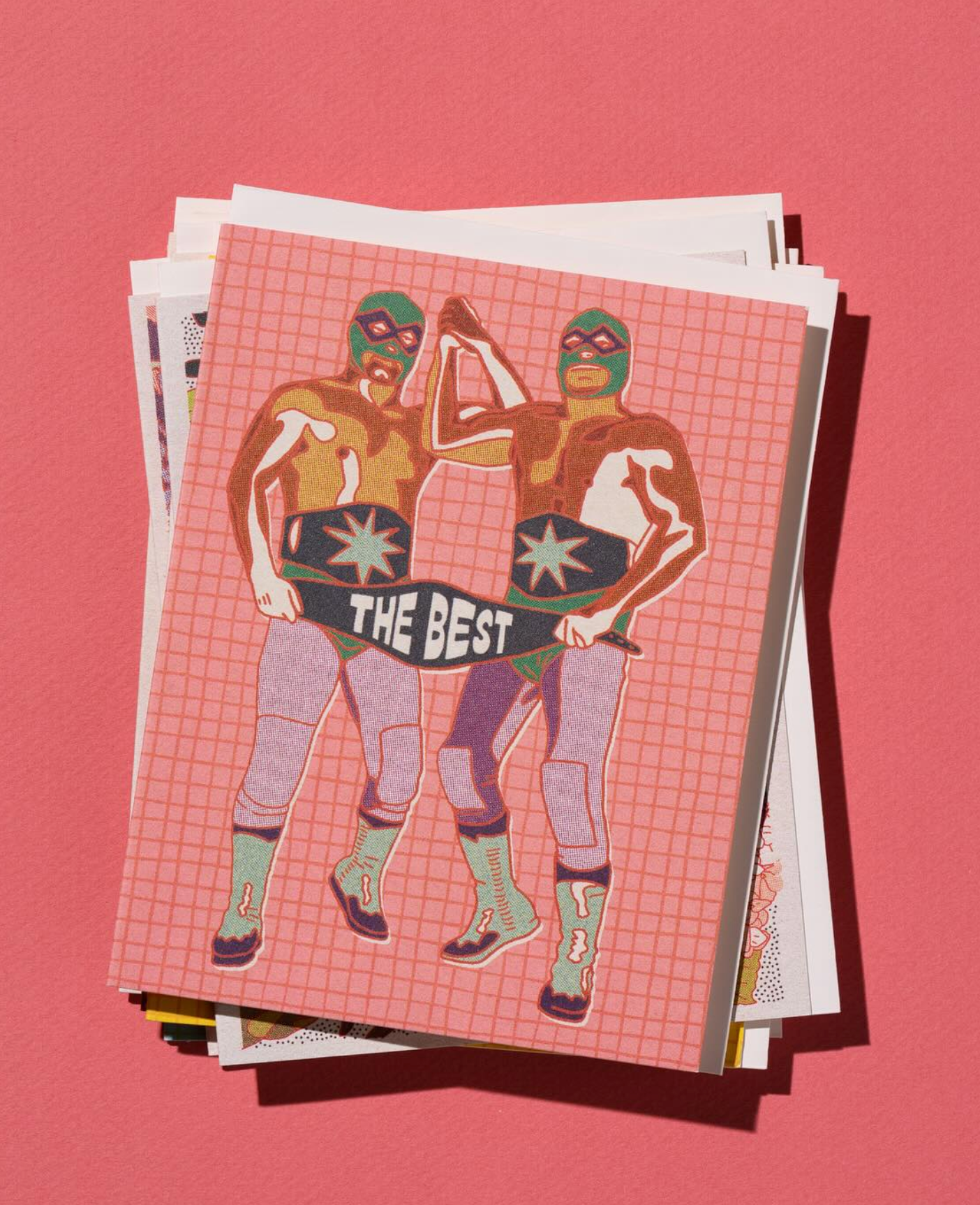 Stack of greeting cards with superhero design on a pink background