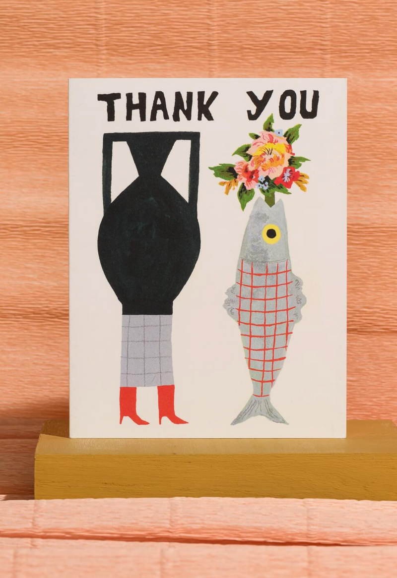 Thank you card with illustration of a vase, fish, and flowers on a wooden surface