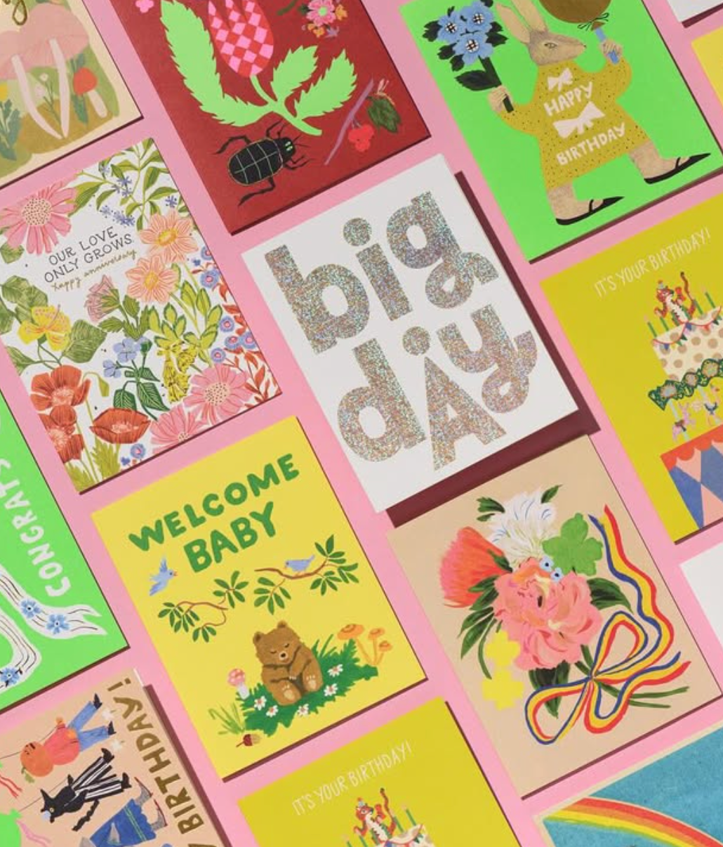 Collection of colorful greeting cards with various designs and text.