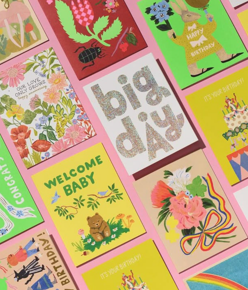 Collection of colorful greeting cards with various designs and text.