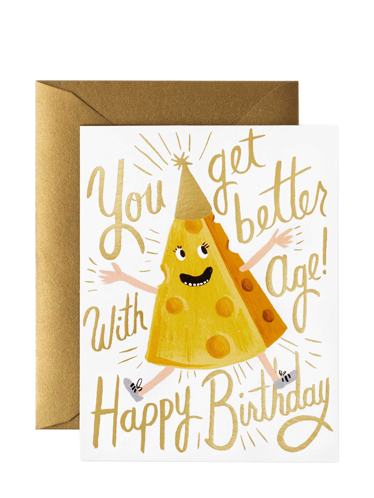 A birthday card with a cartoon image of a smiling cheese character holding a party hat, with the text 'You get BETTER with AGE!' and 'HAPPY BIRTHDAY!' on it, enclosed in a gold envelope.