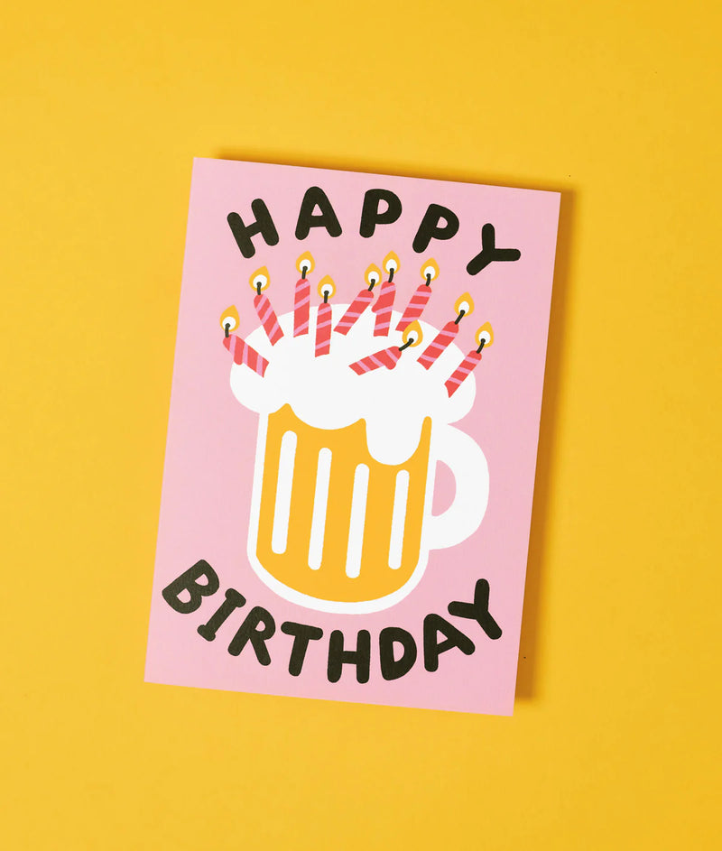 Happy Birthday card with a mug of beer and candles on a yellow background