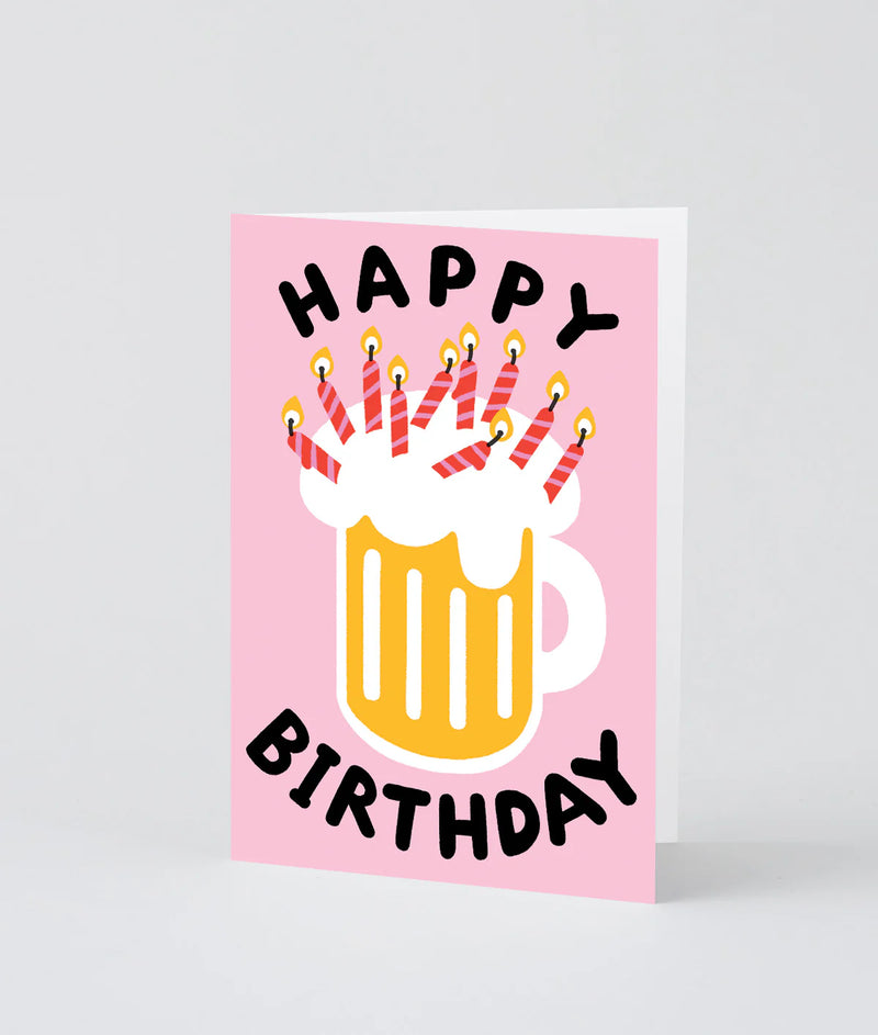 Birthday card with a mug of beer and candles on a pink background